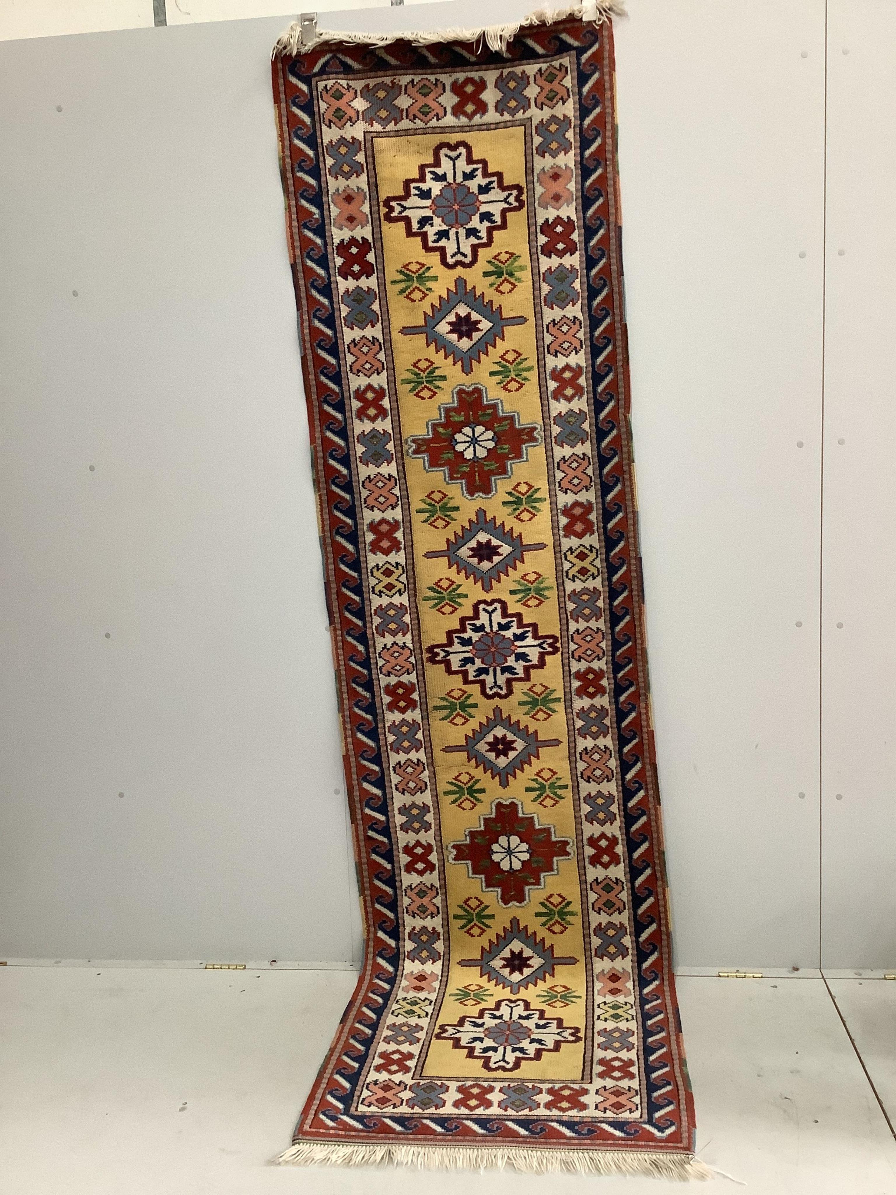 A Caucasian style gold ground runner, 300 x 80cm. Condition - fair